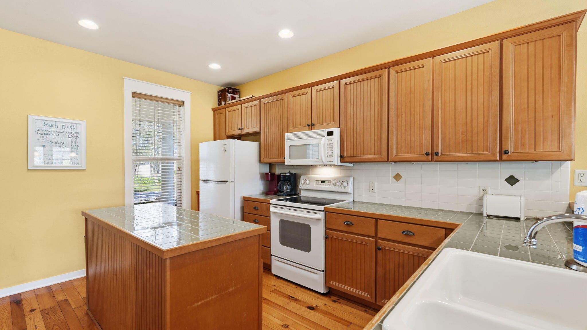 1327 Ravens Run East Miramar Beach, FL 32550 - Photo 18 of 59 a kitchen that has a sink and a stove in it