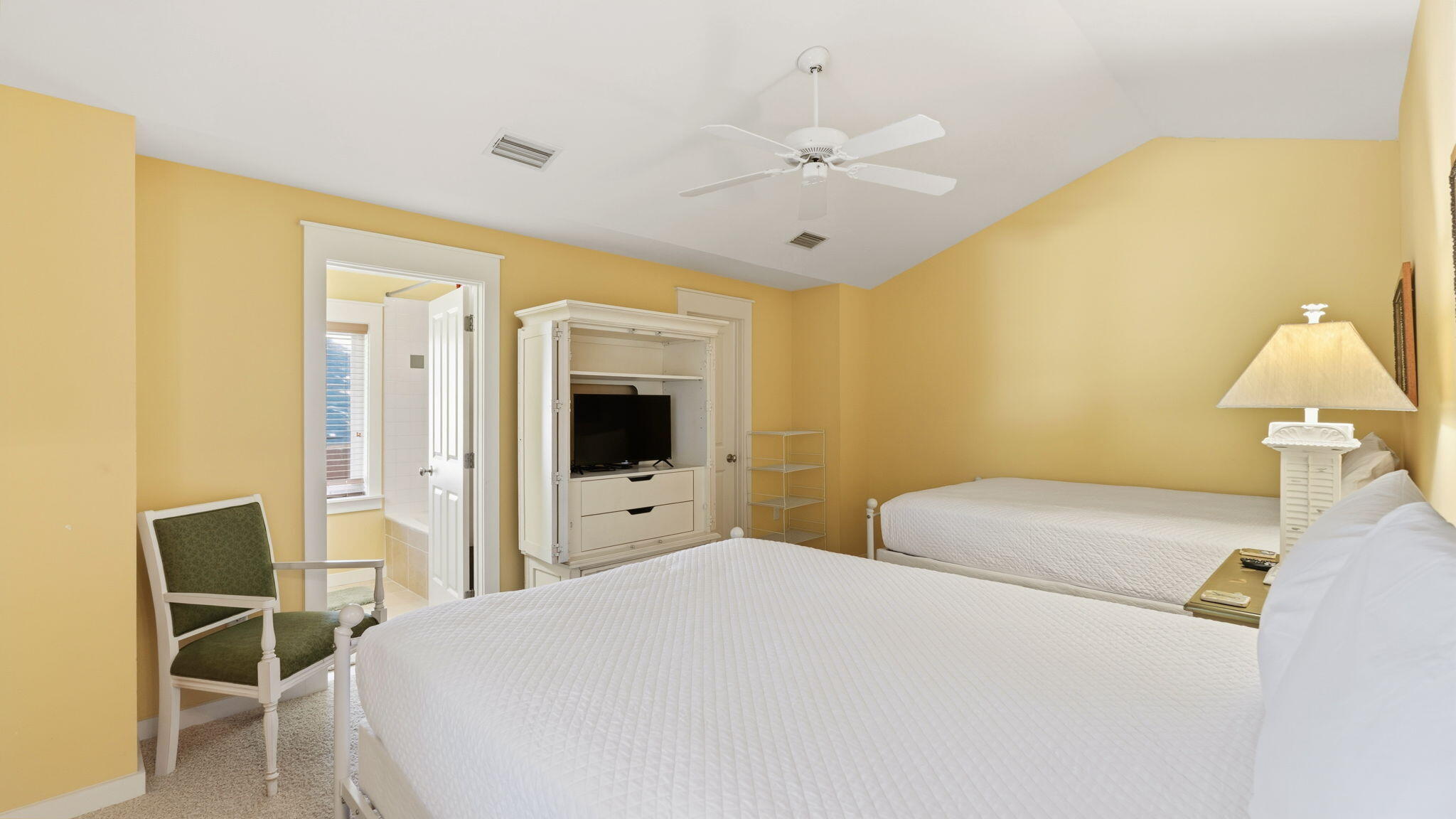 1327 Ravens Run East Miramar Beach, FL 32550 - Photo 26 of 59 a bedroom with a bed and a chandelier