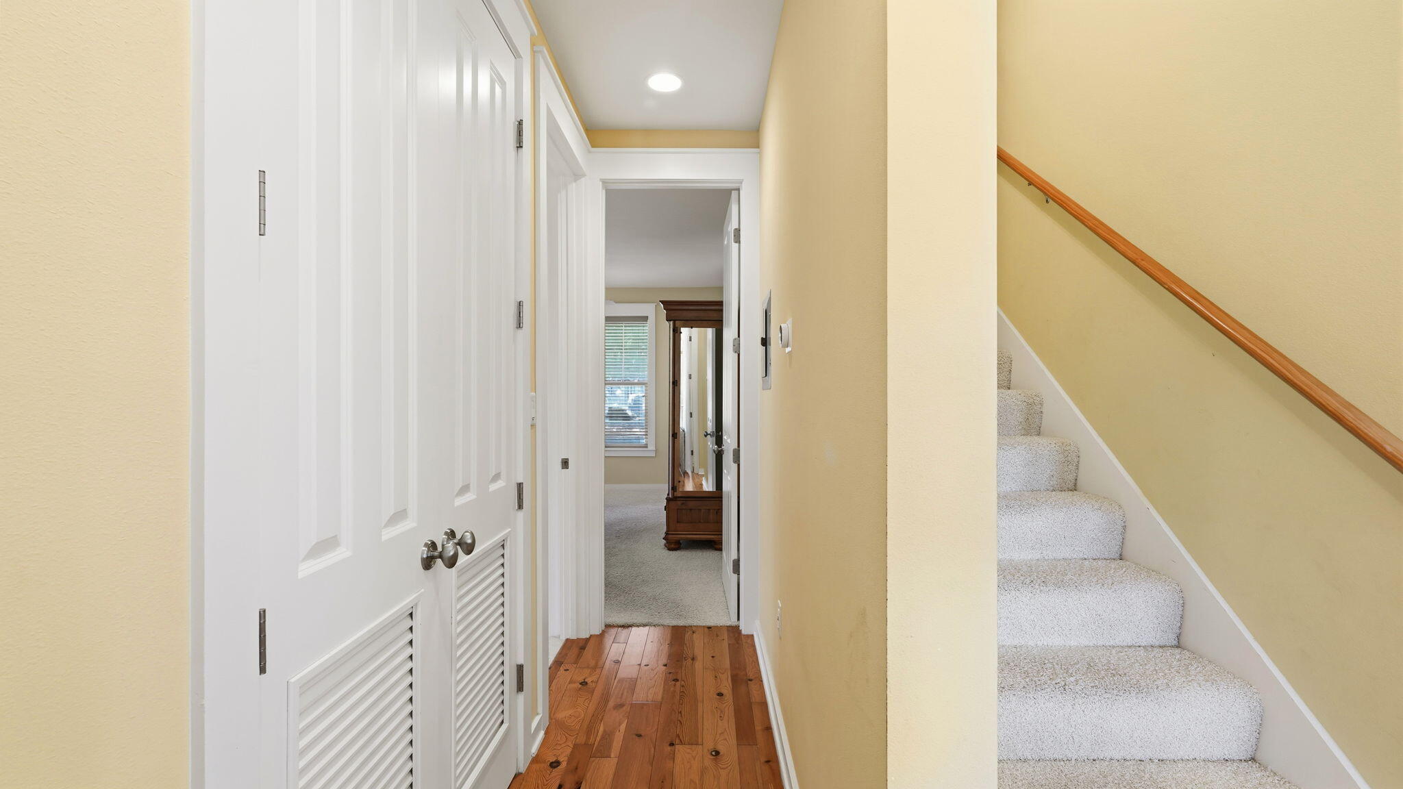 1327 Ravens Run East Miramar Beach, FL 32550 - Photo 32 of 59 a view of a hallway with wooden floor and staircase