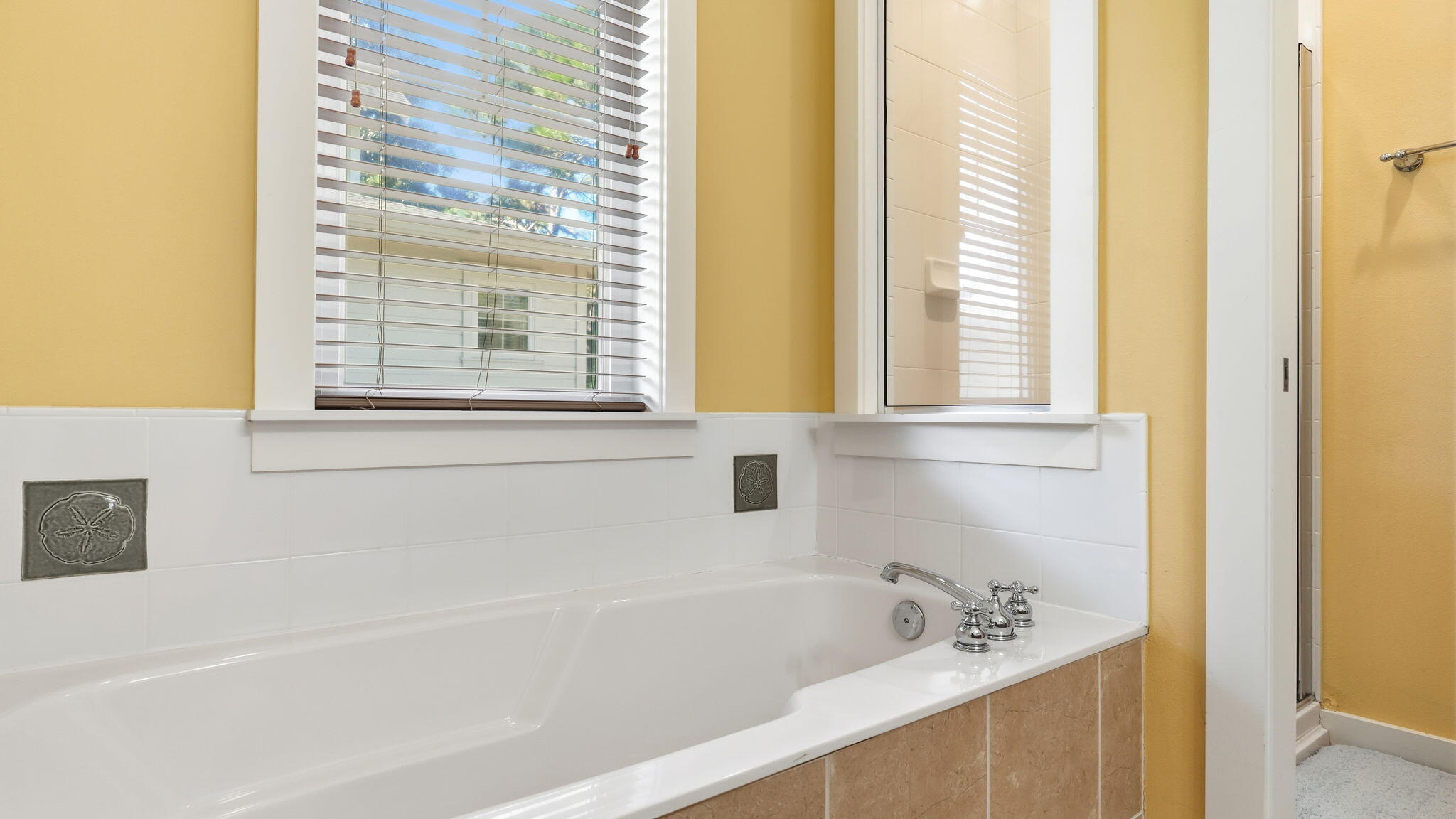 1327 Ravens Run East Miramar Beach, FL 32550 - Photo 33 of 59 a white bath tub sitting next to a window