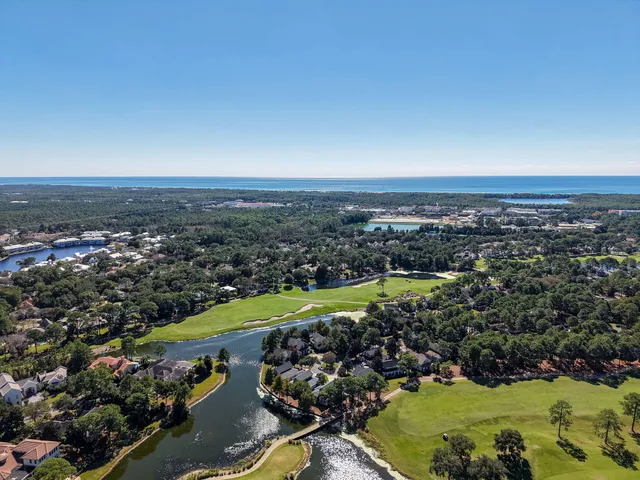 an aerial view of multiple houses with yard