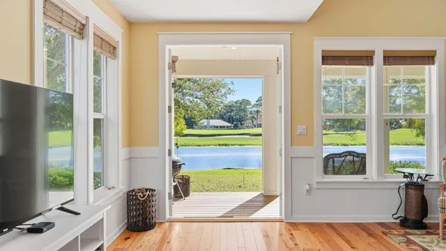 a living room with furniture dining table and a large window