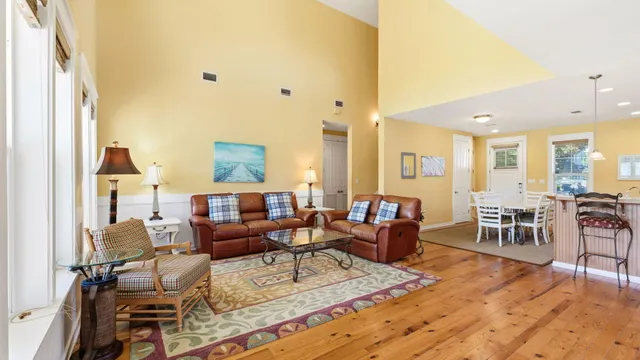 a living room with furniture a flat screen tv and a large window
