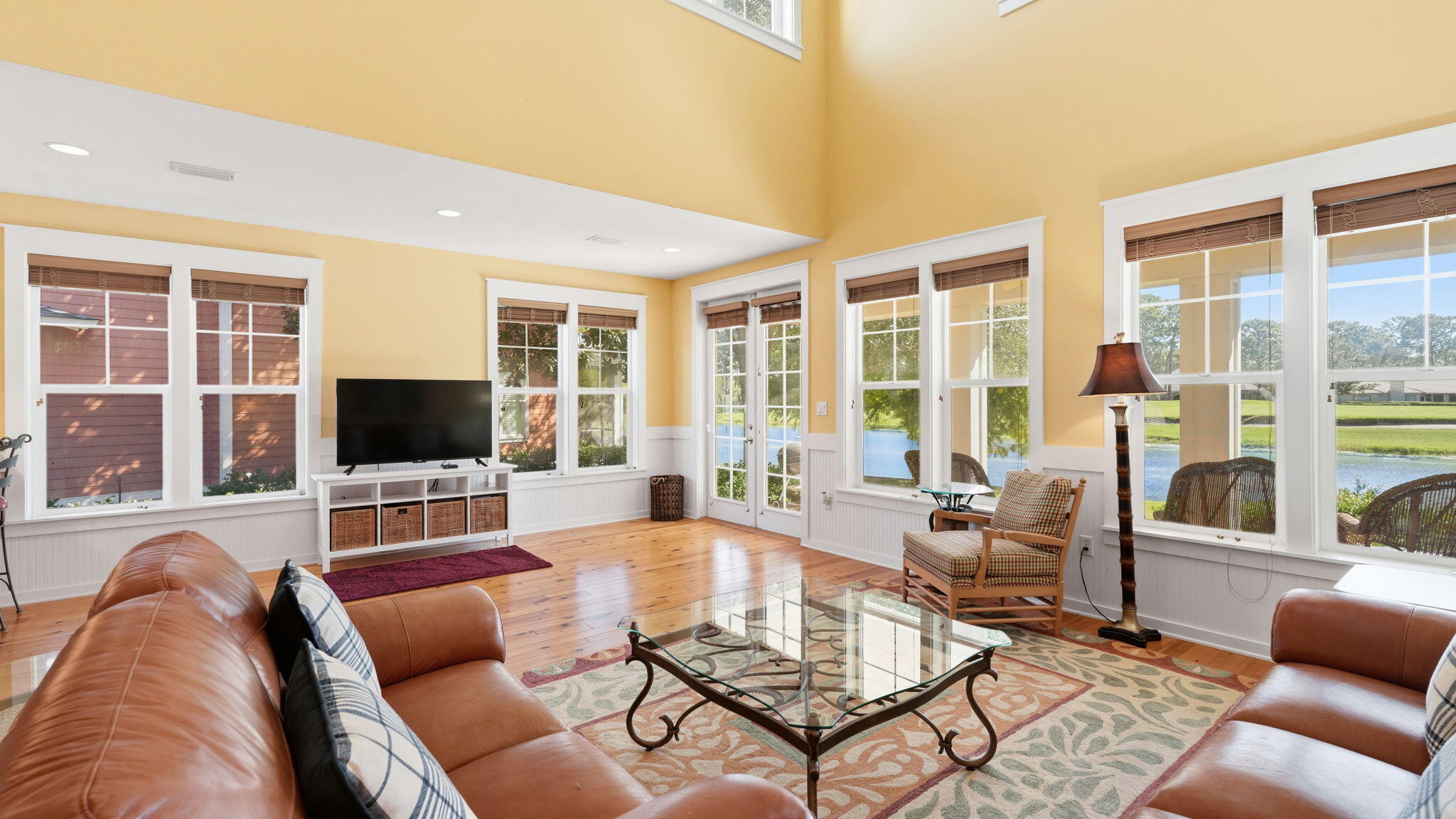 1327 Ravens Run East Miramar Beach, FL 32550 - Photo 10 of 59 a living room with furniture a flat screen tv and a large window