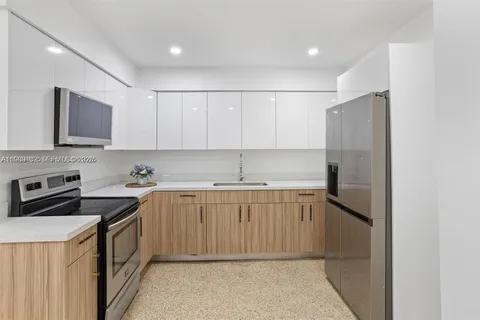 a kitchen with a sink stove and refrigerator