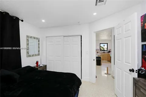 a bed room with a bed and a television