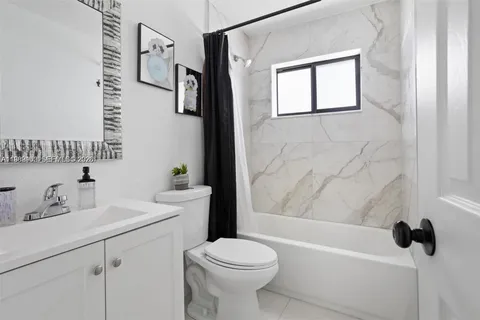 a bathroom with a sink a toilet and a bathtub