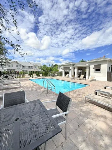 a view of house with swimming pool outdoor seating