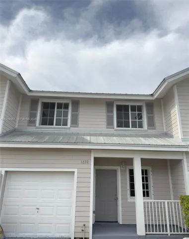 a front view of a house with garage