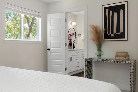 a bedroom with a bed and a mirror