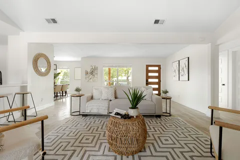 a kitchen with stainless steel appliances granite countertop a stove a sink and a refrigerator