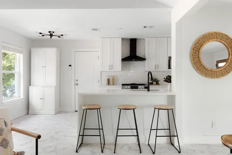 a kitchen with stainless steel appliances a sink stove and cabinets
