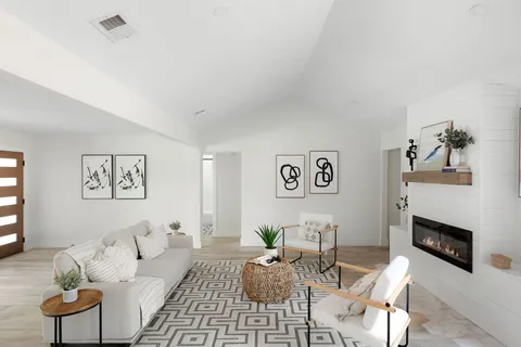 a living room with furniture a fireplace and a flat screen tv