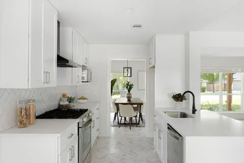 a kitchen with a sink cabinets and appliances