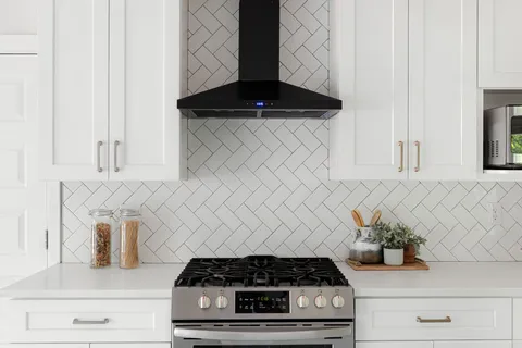 a kitchen with a stove and cabinets