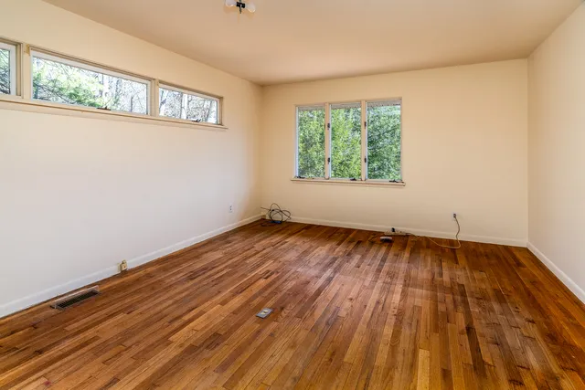a view of a hallway with wooden walls