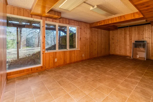 a bedroom with a bed and a large window