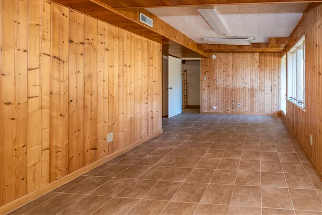 a view of a hallway with a chandelier fan and wooden floor