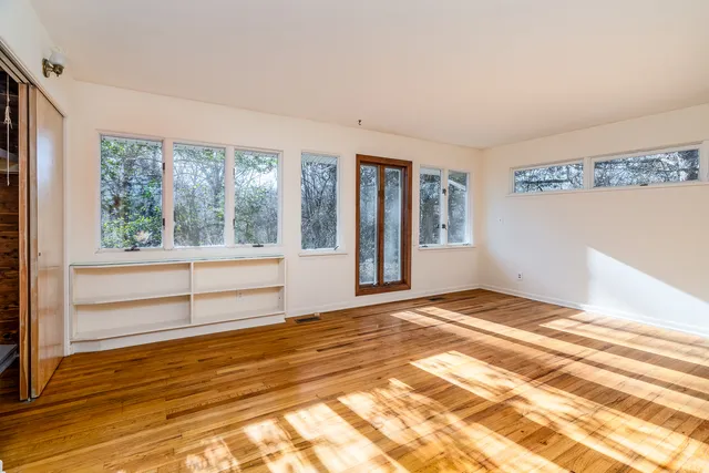 a view of walk in closet with empty racks