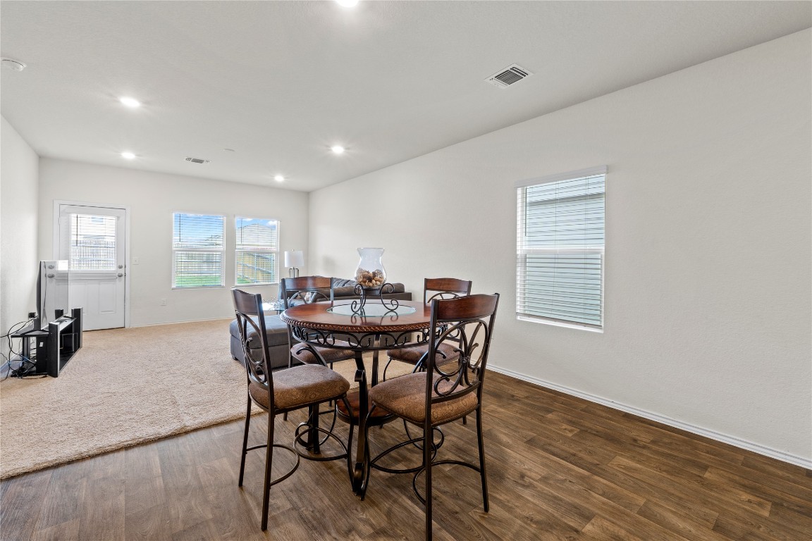 14806 Bajada Road Manor, TX 78653 - Photo 13 of 28 a view of a dining room with furniture and wooden floor