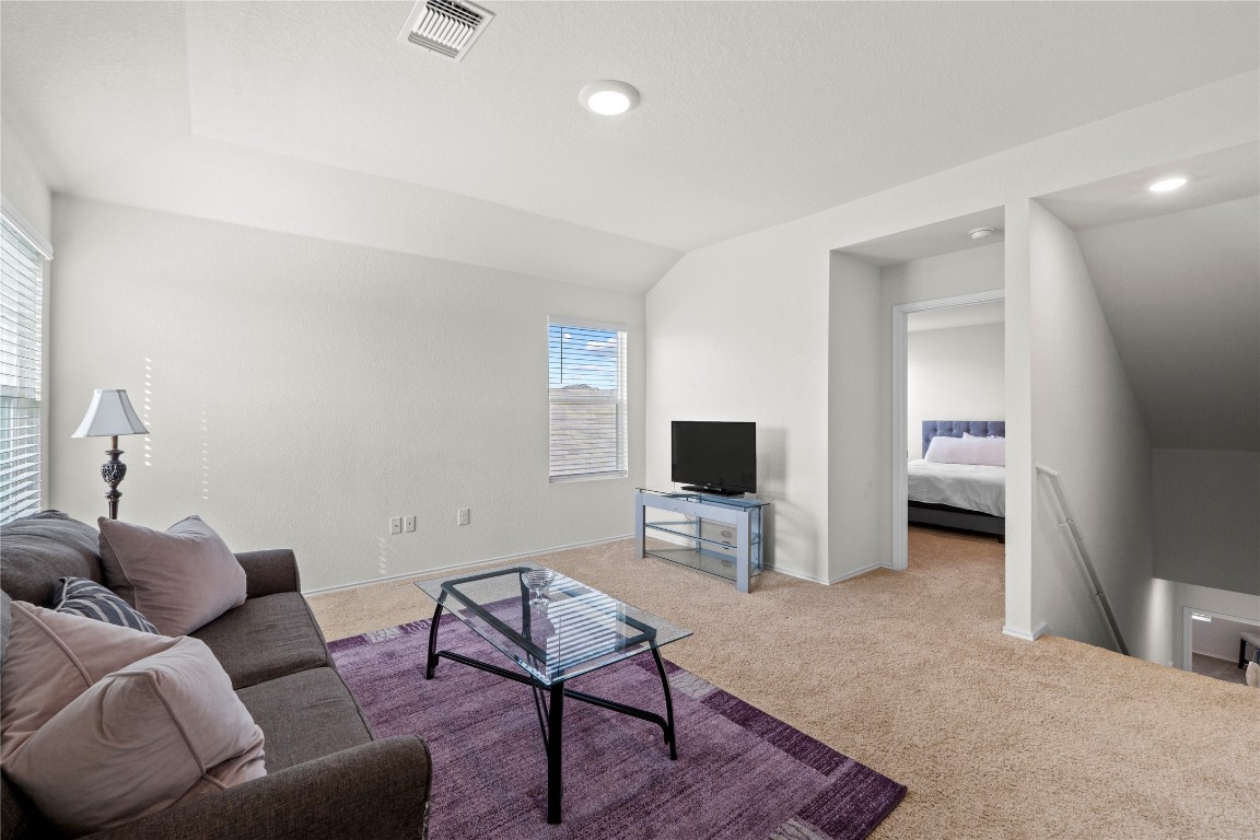 14806 Bajada Road Manor, TX 78653 - Photo 19 of 28 a living room with furniture and a flat screen tv
