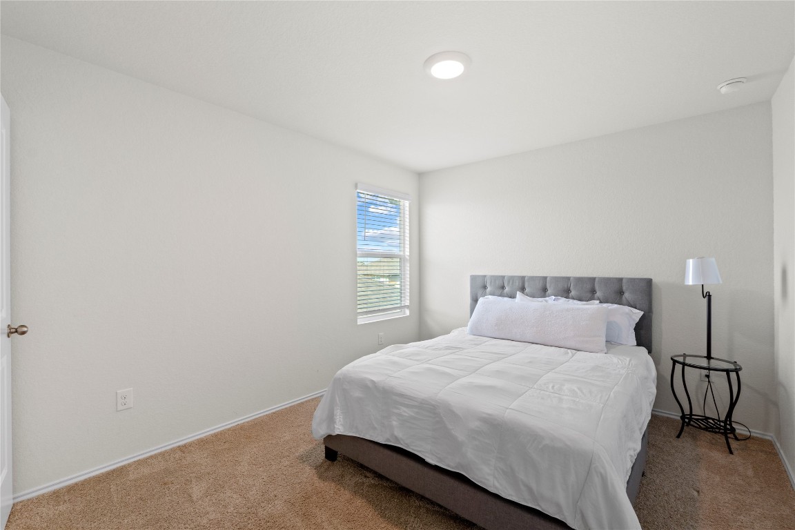 14806 Bajada Road Manor, TX 78653 - Photo 20 of 28 a bedroom with a bed and a window