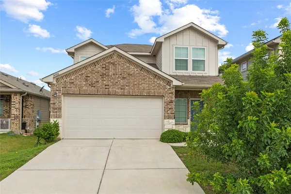 a view of house with garage and entertaining space