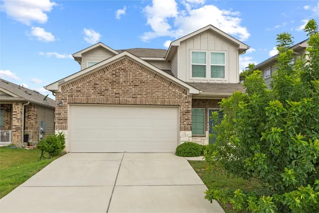 a view of house with garage and entertaining space
