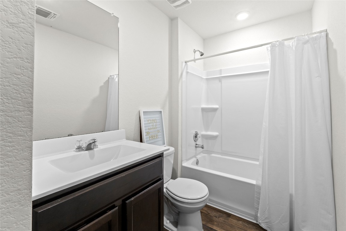 14806 Bajada Road Manor, TX 78653 - Photo 21 of 28 a bathroom with a sink a toilet and shower