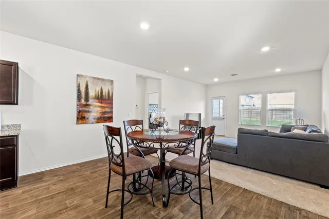 a view of a dining room with furniture window and wooden floor