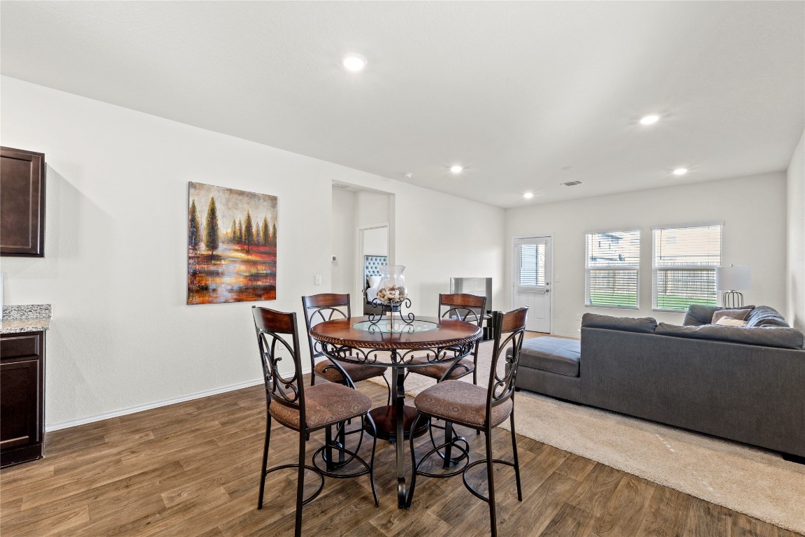14806 Bajada Road Manor, TX 78653 - Photo 5 of 28 a view of a dining room with furniture window and wooden floor