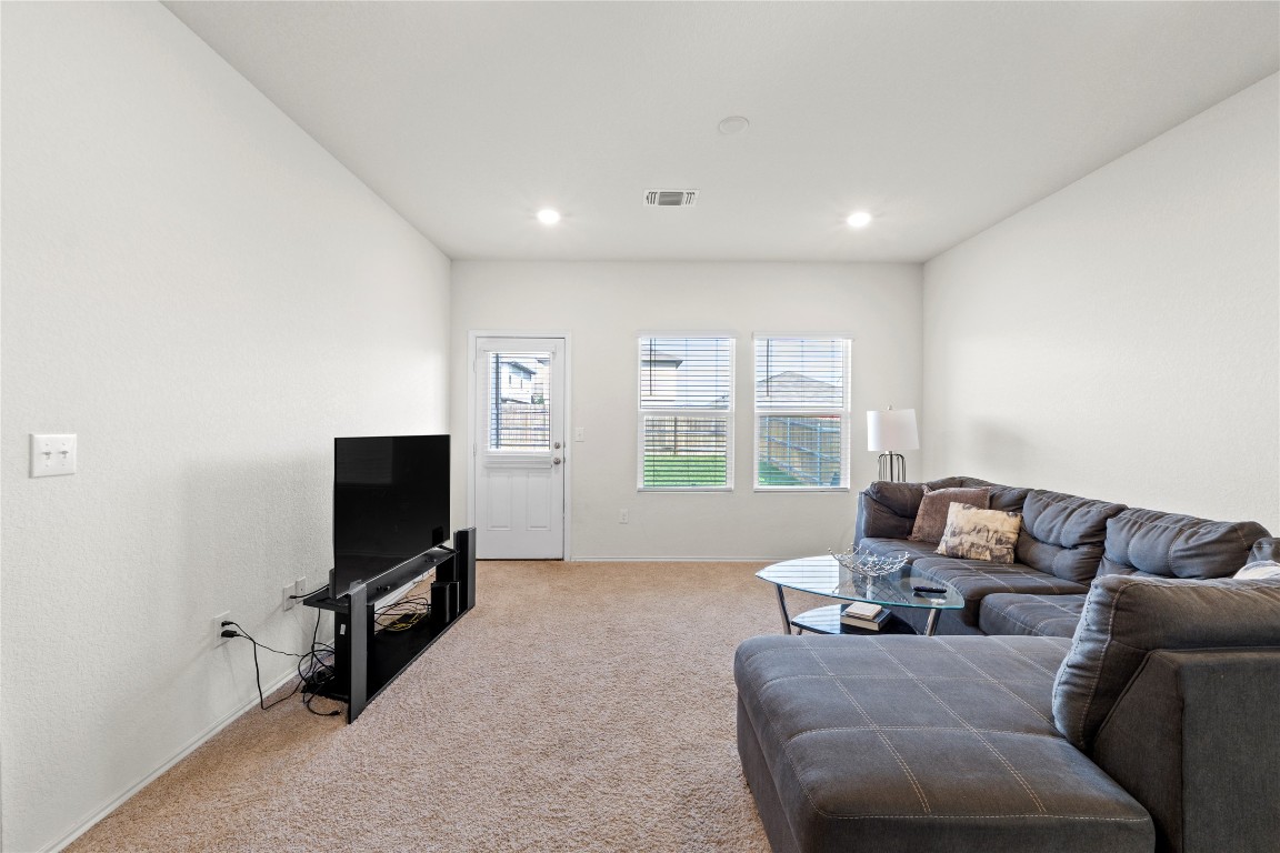 14806 Bajada Road Manor, TX 78653 - Photo 6 of 28 a living room with furniture and a flat screen tv