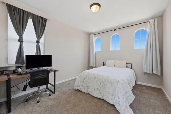 a bedroom with a bed and a desk