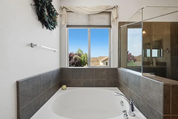 a bath tub sitting in a bathroom next to a window