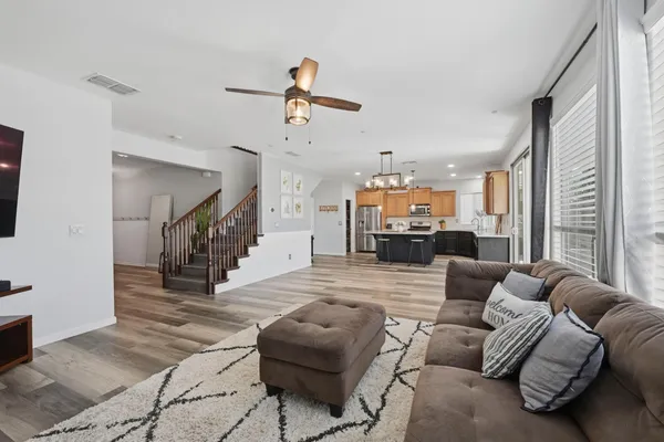 a living room with furniture and a chandelier