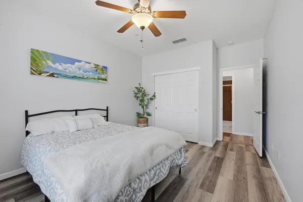 a bedroom with a bed and a chandelier