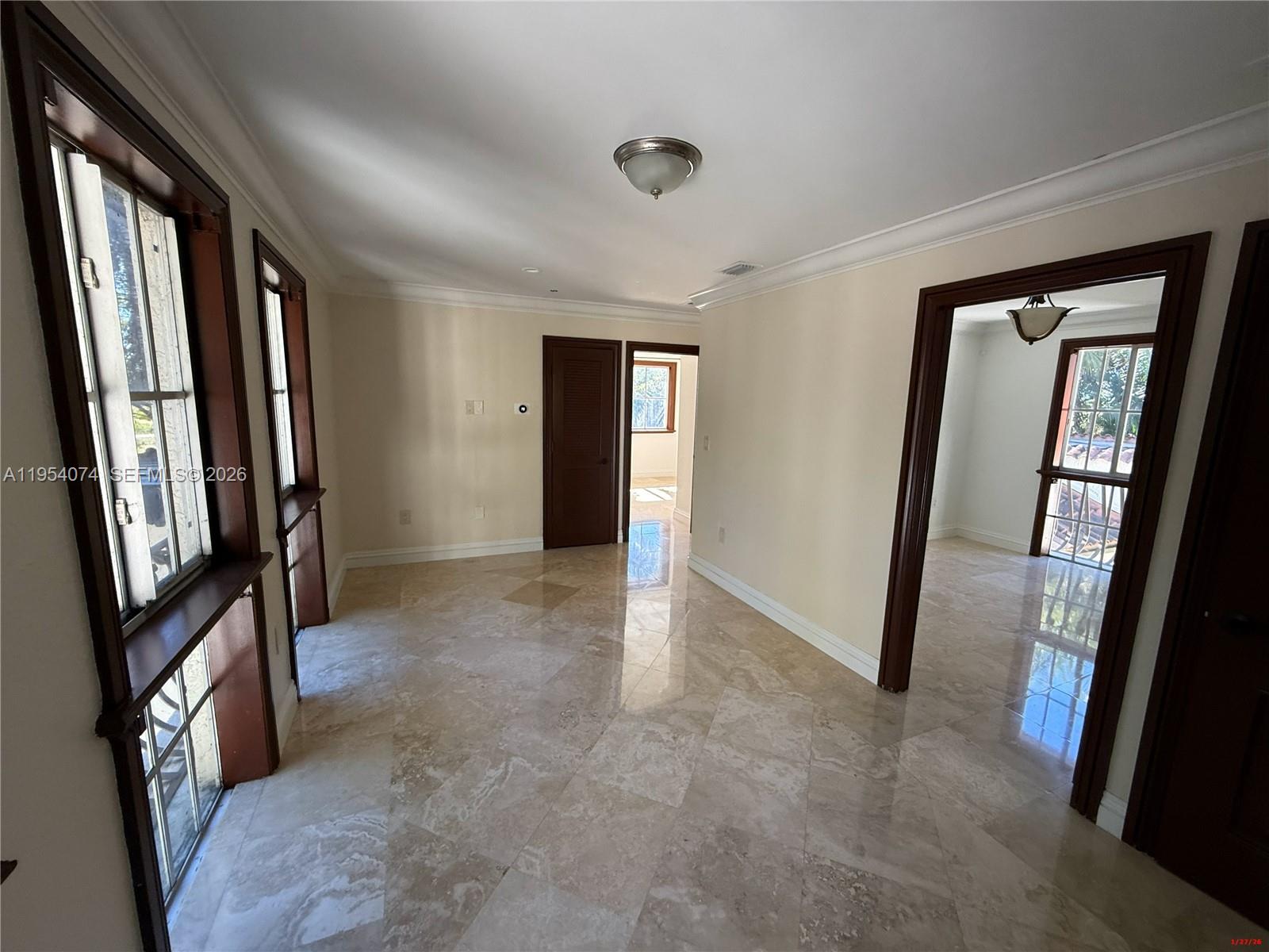 19950 Southwest 228th Street Miami, FL 33170 - Photo 11 of 24 a view of a hallway with large windows
