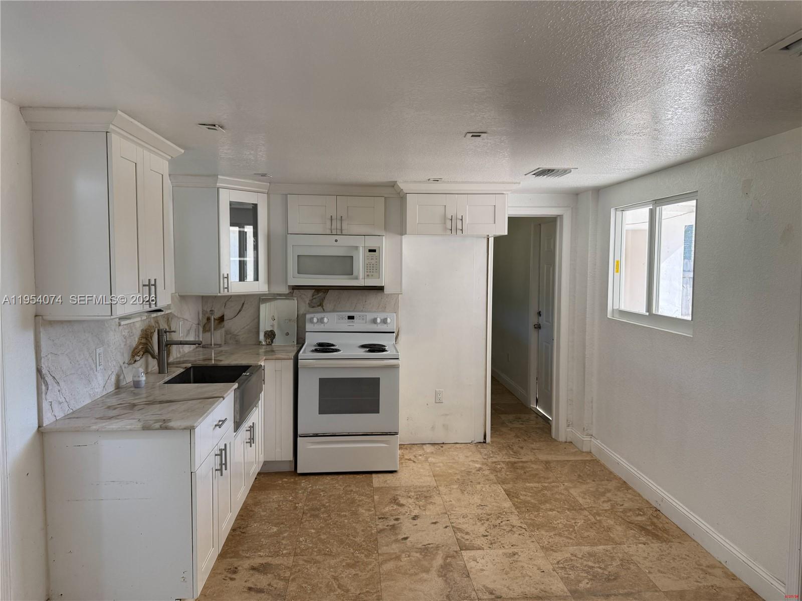 19950 Southwest 228th Street Miami, FL 33170 - Photo 21 of 24 a kitchen with stainless steel appliances a stove a sink and a refrigerator