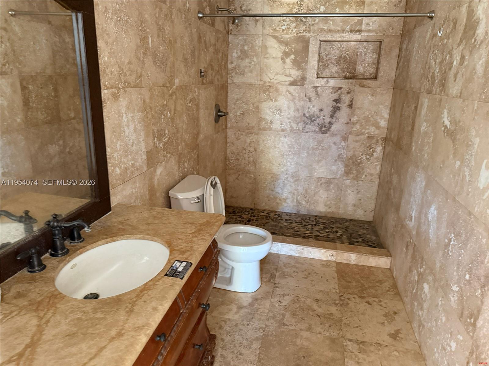 19950 Southwest 228th Street Miami, FL 33170 - Photo 23 of 24 a bathroom with a granite countertop sink toilet a mirror and shower