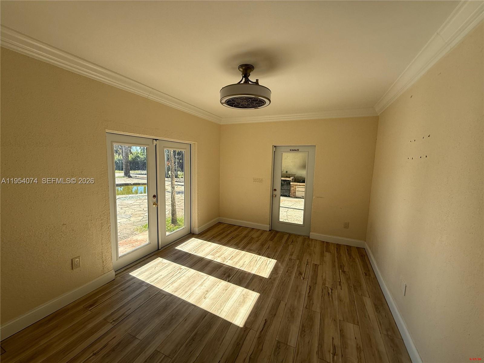 19950 Southwest 228th Street Miami, FL 33170 - Photo 7 of 24 a bedroom with a bed and wooden floor