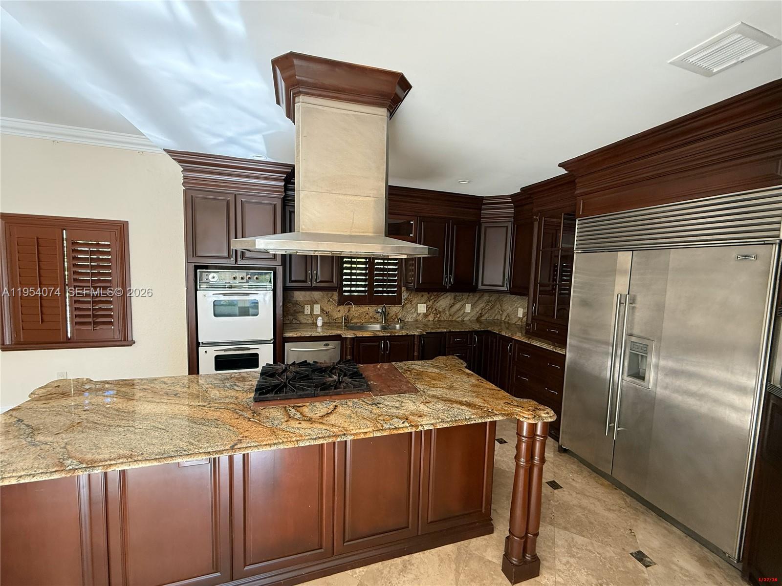 19950 Southwest 228th Street Miami, FL 33170 - Photo 8 of 24 a kitchen with a refrigerator and a stove