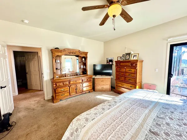 a bedroom with a bed and a painting on the wall