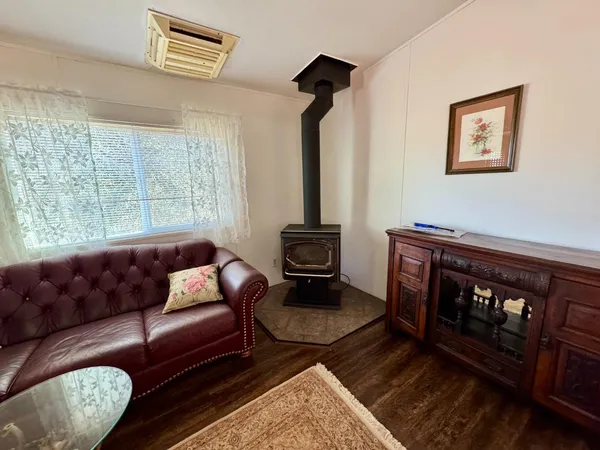 a kitchen with granite countertop a sink cabinets stainless steel appliances and wooden floor