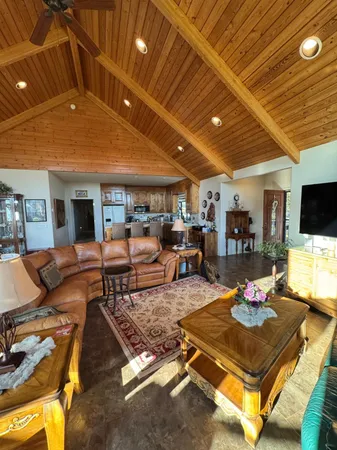 a living room with furniture and a floor to ceiling window