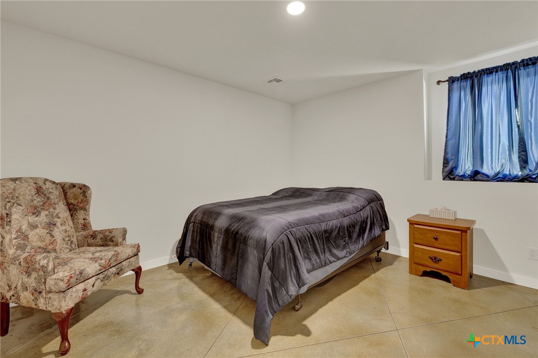 305 Lake Crest Spring Branch, TX 78070 - Photo 22 of 38 a spacious bedroom with a bed and a couch