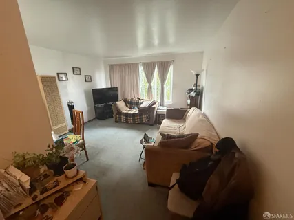 a living room with furniture rug and a window