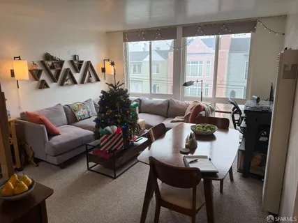 a living room with furniture and floor to ceiling windows