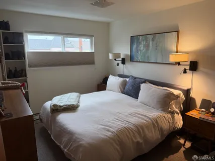 a bedroom with bed and window