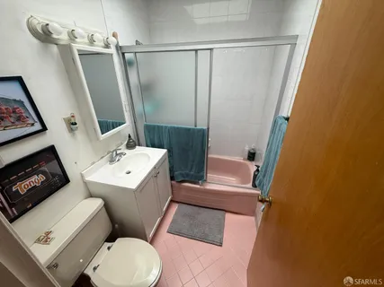 a bathroom with a sink toilet and shower