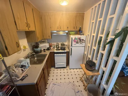 a kitchen with a sink a stove a washer and dryer